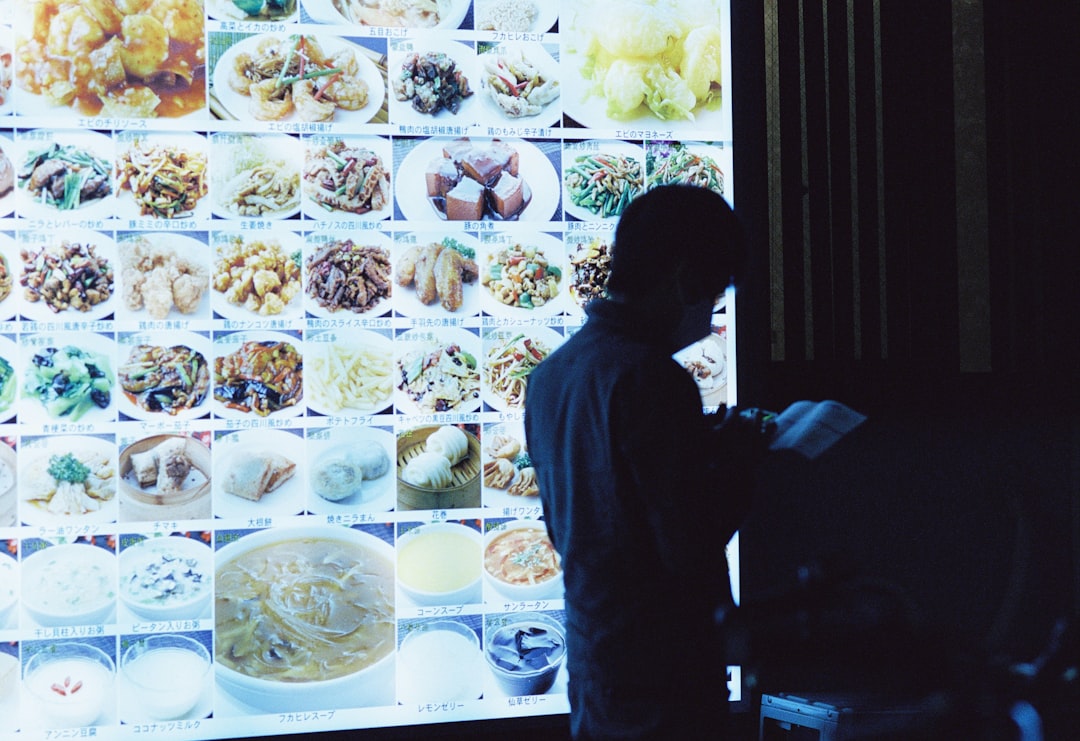 a man standing in front of a large display of food