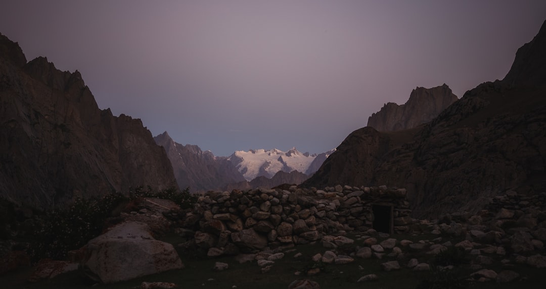 A mountain range with a dark sky in the background