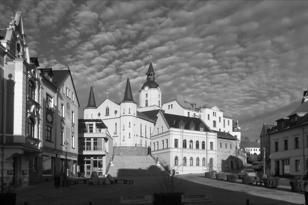 Historic buildings and dramatic sky in european town square.