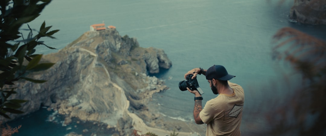 a man taking a picture of a body of water