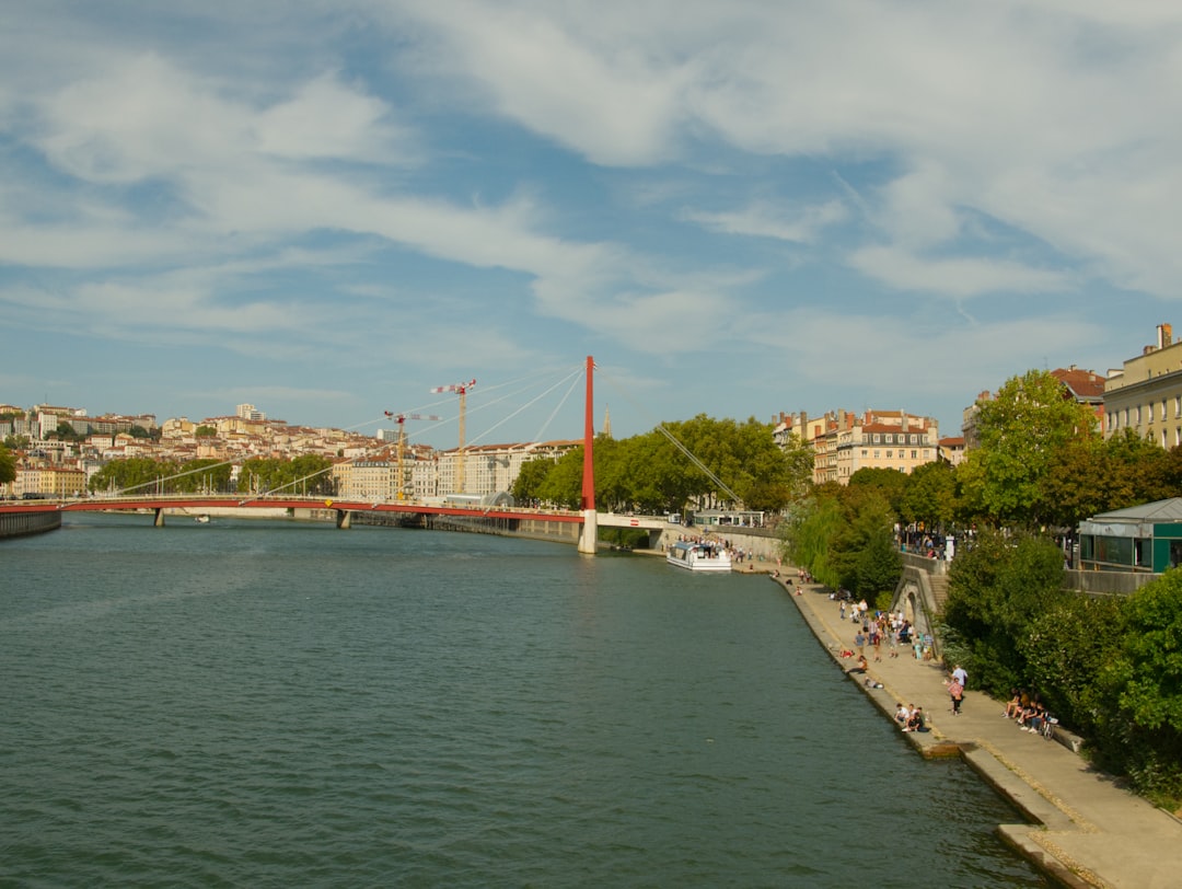 red metal bridge under blue sky and white clouds