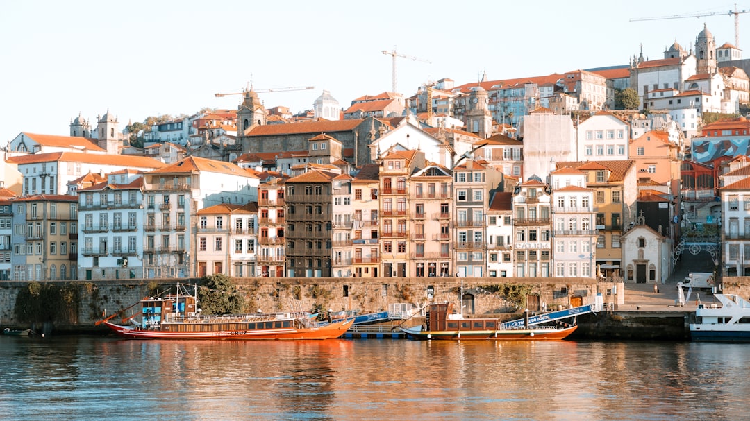 Colorful buildings line a river with boats.